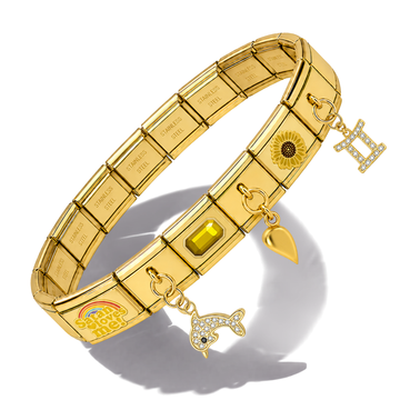 Gold-toned stainless steel charm bracelet with engraved name plates, a rainbow charm, a sunflower charm, a heart charm, a fish charm, and a letter 'H' charm, displayed on a white background with a soft shadow.