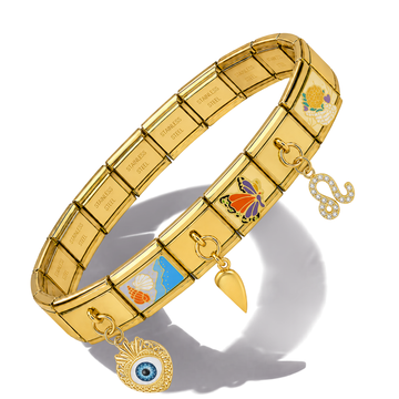 Gold-tone elastic charm bracelet with engraved name plates, butterfly and seashell motifs, and dangling charms including an evil eye pendant, set against a white background with a soft shadow.
